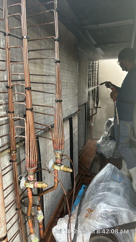 Technician cleaning HVAC air ducts in a residential or commercial building using specialized equipment
