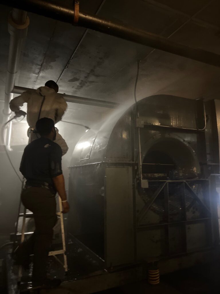 Technician cleaning air ducts in a residential or commercial building to improve air quality and flow.