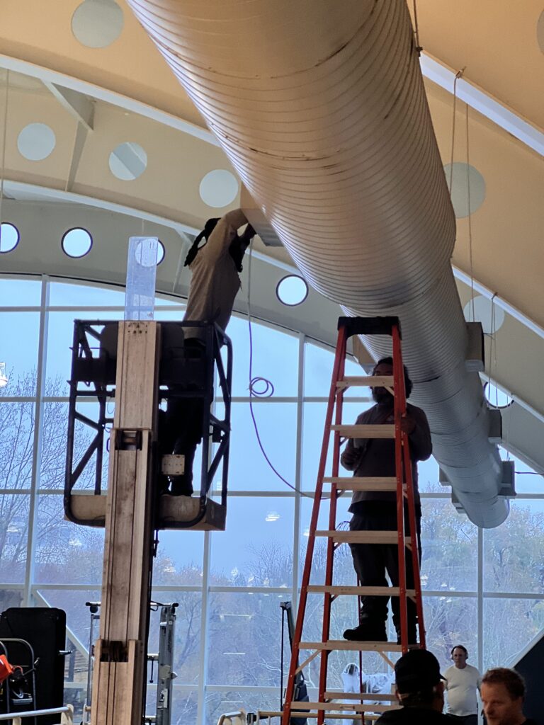 a team of HVAC technicians cleaning a commercial air duct system