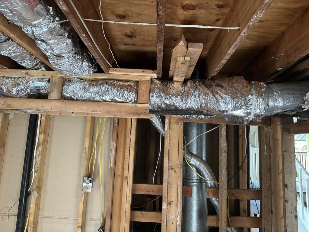 Exposed residential air ducts and HVAC system in need of professional cleaning for improved air quality