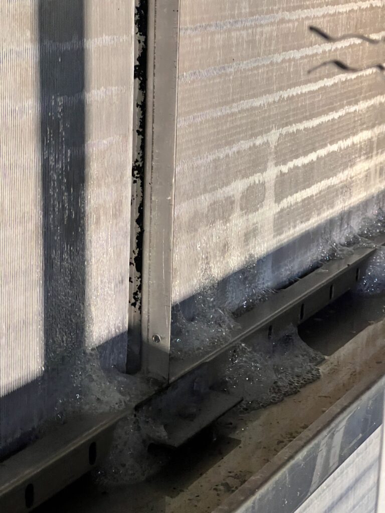 Dirty air duct filled with dust and debris before professional cleaning service