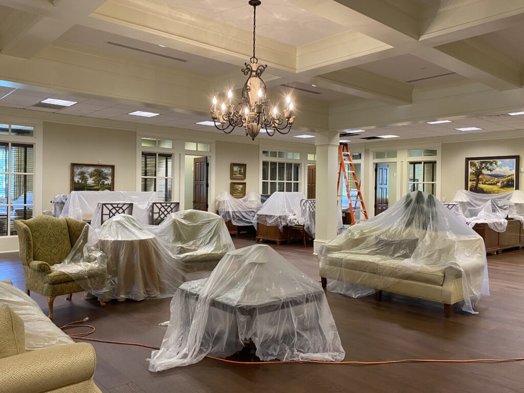 Elegant living room with covered furniture during professional air duct cleaning service
