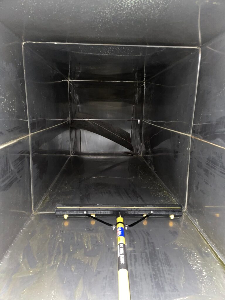 Dirty air duct before professional cleaning service, showing accumulated dust and debris buildup